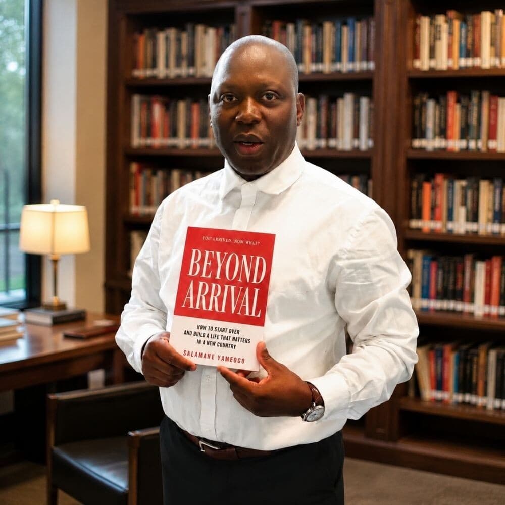 Salamane Yameogo holding his book Beyond Arrival